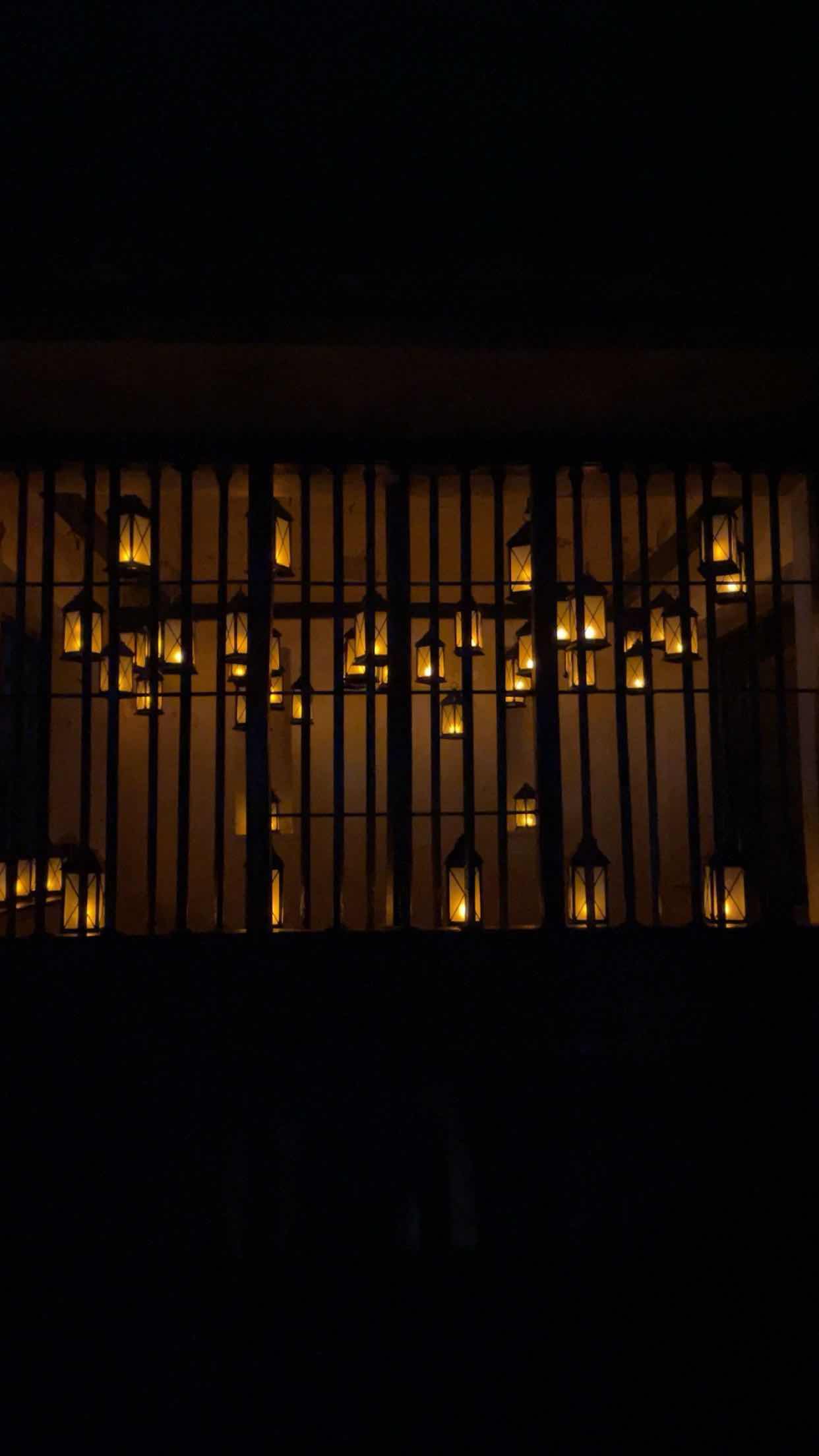 lanterns behind bars in window